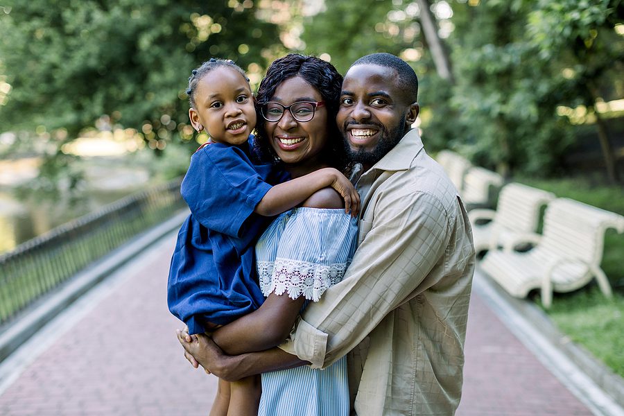 Young Happy African Family Of Three, Parents And Pretty Little D Family Assistance